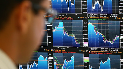 LONDON, ENGLAND - OCTOBER 20:  An employee views trading screens at the offices of Panmure Gordon and Co on October 20, 2014 in London, England. Markets stabilised over the weekend following global turbulence amid fears over the Ebola virus and global economic concerns.  (Photo by Carl Court/Getty Images)